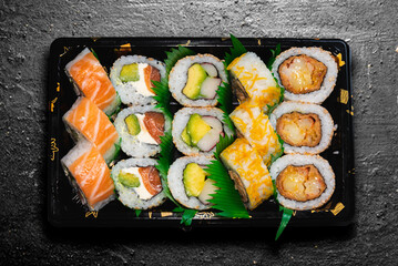 variety of sushi, on dark background, zenithal view, healthy food