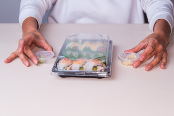 person with sushi platter, delivery, fast food