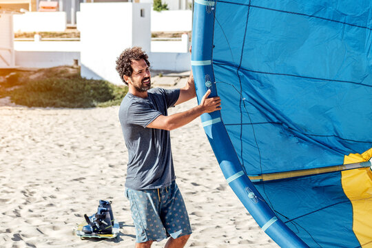 Man preparing kiteboarding kite before kitesurfing. Preparation before kiting.