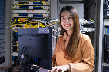 Technician performing maintenance tasks in a server room rack
