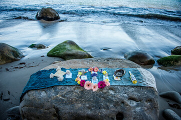 Woman in ceremony at an altar by the sea..