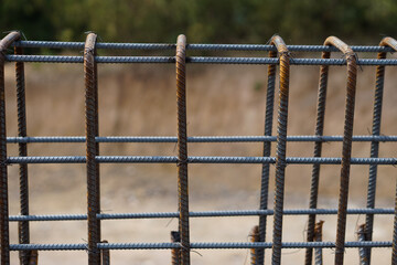 Rebar iron to be used for concrete foundation of new building at construction site. Wire steel rod to reinforce structure of   building.                