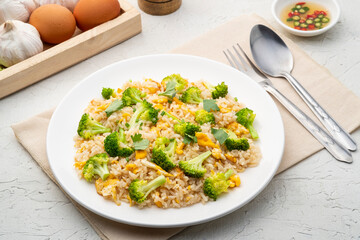 Fried rice with broccoli and egg in white plate.Easy food
