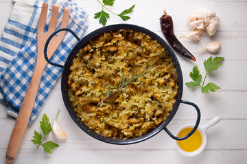 Mountain rice cooked in the oven in paella. Typical tapa recipe with pork and rabbit meat.