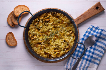 Mountain rice cooked in the oven in paella. Typical tapa recipe with pork and rabbit meat.