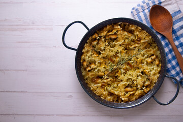 Mountain rice cooked in the oven in paella. Typical tapa recipe with pork and rabbit meat.