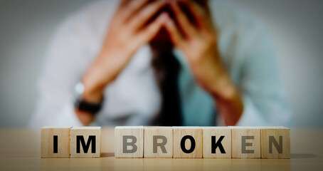 A young man who is disappointed in work, business and love, has a lump in front of it saying 'Okay, I'm broken.