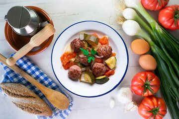 Beef meatballs with tomato sauce and assorted vegetables. Typical Spanish tapas recipe.
