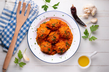 Beef meatballs with tomato sauce and assorted vegetables. Typical Spanish tapas recipe.