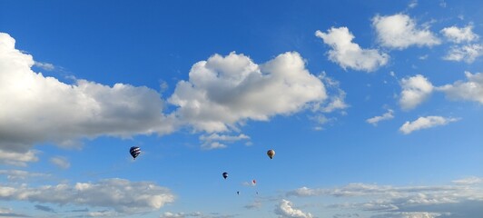 Several hot air balloons in the air, clear blue skies, York, England.