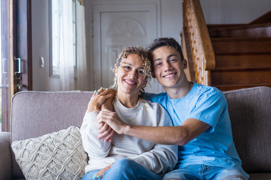 Portrait of grateful teenager man hug smiling middle-aged mother show love and care, thankful happy grown-up son in embrace cheerful mom, enjoy weekend family time at home together, bonding concept.