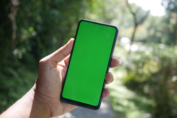 rear view of young man using smart phone at outdoor 