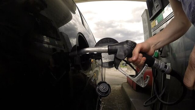 man refuel his car - Close-up video