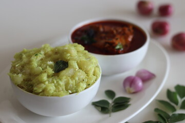 Mashed tapioca served with pomfret fish curry. Boiled and strained tapioca pieces mashed with spiced coconut taste best with fish curry prepared in Kerala style