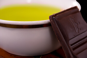 cup without a handle with green teas on coasters
