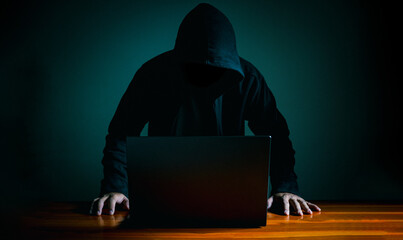 Hackers work on laptops in the dark. The concept of information security in the Internet network...