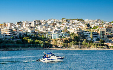 Fototapeta na wymiar Motorboat leaving the marina Zeas at Piraeus port. Greece.