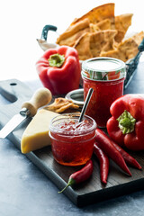 Sweet hot pepper jelly served with cheese and cracker bread for dipping.