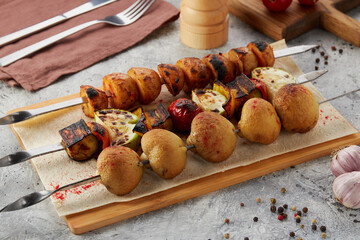 mushrooms, potatoes and grilled zucchini on a skewer