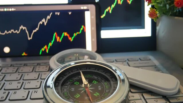 Stock graph and compass set on computer