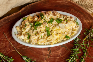 Portion of manioc farofa with eggs, typical Brazilian dish called farofa de ovos