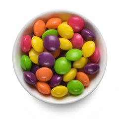 Foto auf Acrylglas Colorful round candies in white bowl isolated on white. Top view. © Kuzmick