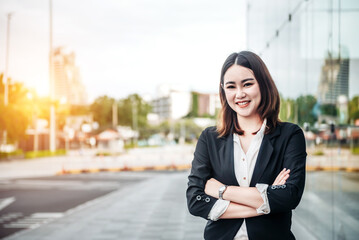 Fototapeta premium Portrait of Asian business woman smiling and embrace outdoor of her office or airport