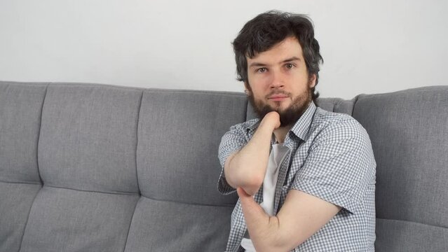 Handicapped disabled man with amputated two stump hands working typing on laptop at home looking at camera. Problem of adaptation to life people with disabilities. Independent Invalid person.
