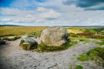 Hill walking on the gritstone outcrops on Higger Tor in the De rbyshire Peak Distrct