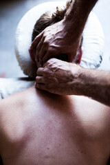 Moody poetic bodywork photograph. Male massage therapist working with female client. 