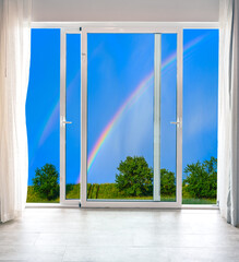 view from the window to the sky with a rainbow