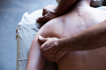 Fototapeta premium Male massage therapist working with a female client. 