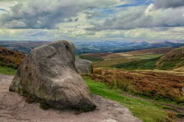 Hill walking on the gritstone outcrops on Higger Tor in the De rbyshire Peak Distrct