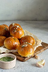 Freshly baked buns (pampushki) with garlic and dill for the first course (soup) on a baking tray. National Ukrainian dish, food. Selective focus.