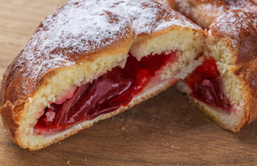 Sweet homemade freshly baked bun on the table. Close-up.