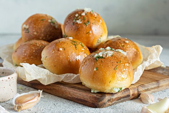 Freshly baked buns (pampushki) with garlic and dill for the first course (soup) on a baking tray. National Ukrainian dish, food. Selective focus.