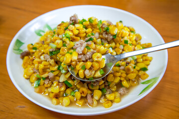 A dish of delicious Chinese home cooking, fried corn with minced meat