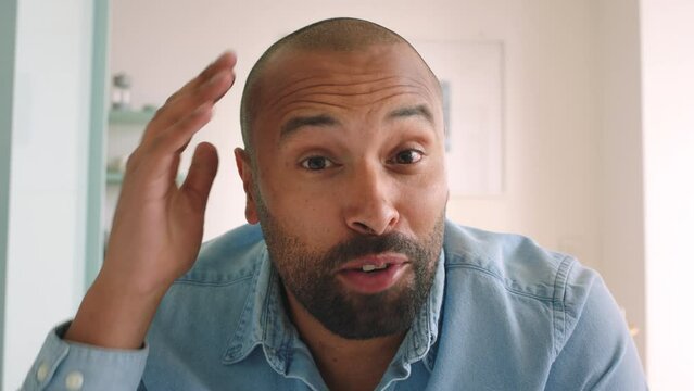 Video call, wave and communication with a man talking, laughing and joking online from his home living room. Internet, technology and conversation with a male speaking and in discussion on the web