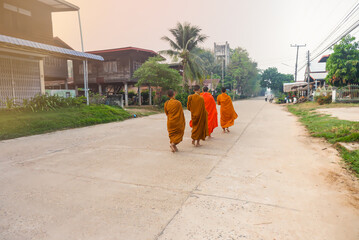 The monks walk for alms in the morning