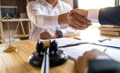 Lawyers shake hands with business people to seal a deal with partner lawyers. or a lawyer discussing contract agreements, handshake concepts, agreements, agreements