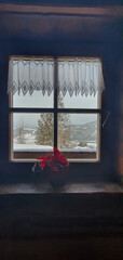A snowstorm seen through a window in a mountain chalet near Falchau in Austria.