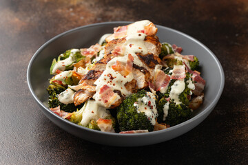 Baked chicken, broccoli with creamy cheese sauce and bacon