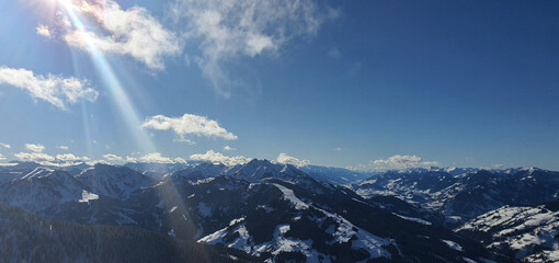 Panorama of the snow capped Alps and the view from the Griessenkareck summit near Flachau in Austria, on a sunny winter day.