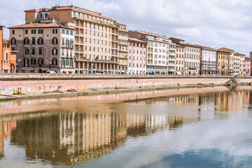 Fototapeta na wymiar Old buildings in the Arno River's edge, iin the Tuscany region and It is the most important river of central Italy after the Tiber. Pisa, 2019
