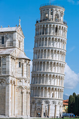 Fototapeta na wymiar The Pisa's Cathedral and The Leaning Tower of Pisa is a medieval structure. The bell tower was built in 1173 in white marble, Italy, 2019