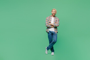 Full body young fun blond man with dreadlocks 20s he wear casual shirt hold hands crossed folded look camera isolated on pastel plain light green background studio portrait. People lifestyle concept.