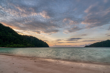 Beautiful sunset at Mai ngam beach in Koh Surin national park, the famous free driving spot in Pang Nga, Thailand.