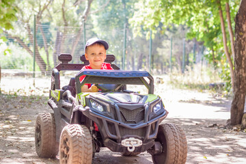 Entertainment park. Little boys compete on children's ATVs and cars. A fun pastime. Natural images with natural emotions.