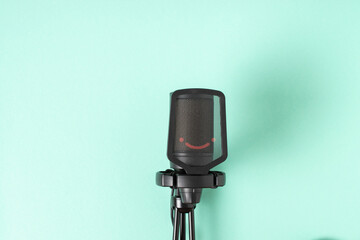 Microphone on a light blue background with a space for text. Space for copying. Flat position, top view