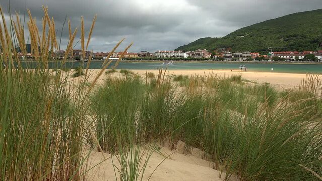Santo&ntilde;a from Puntal de Laredo with dunes in the sand of the beach and vegetation. Cantabria, Spain
